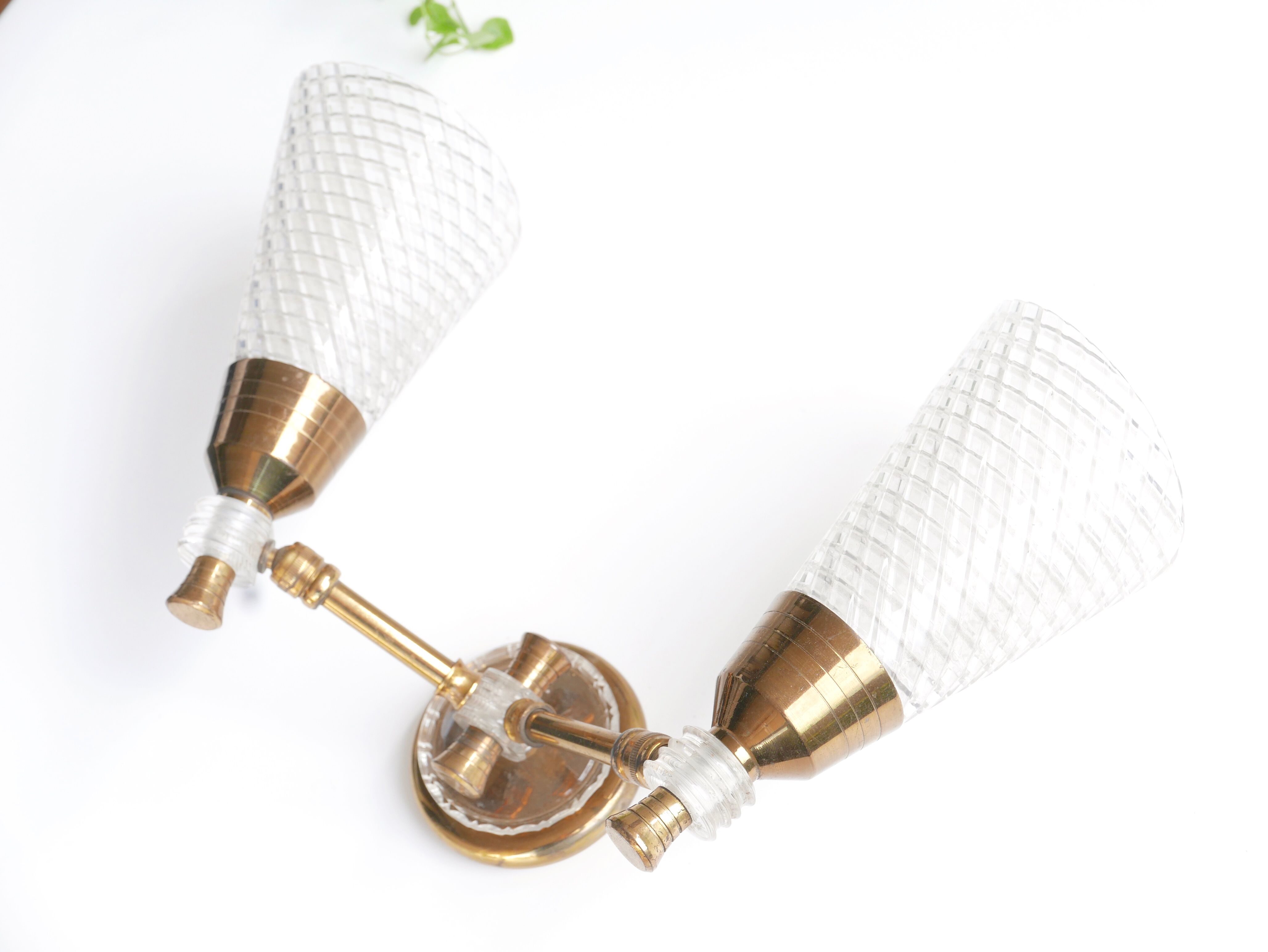 Pair of wall sconces in gold metal and plexiglass, 50 years
