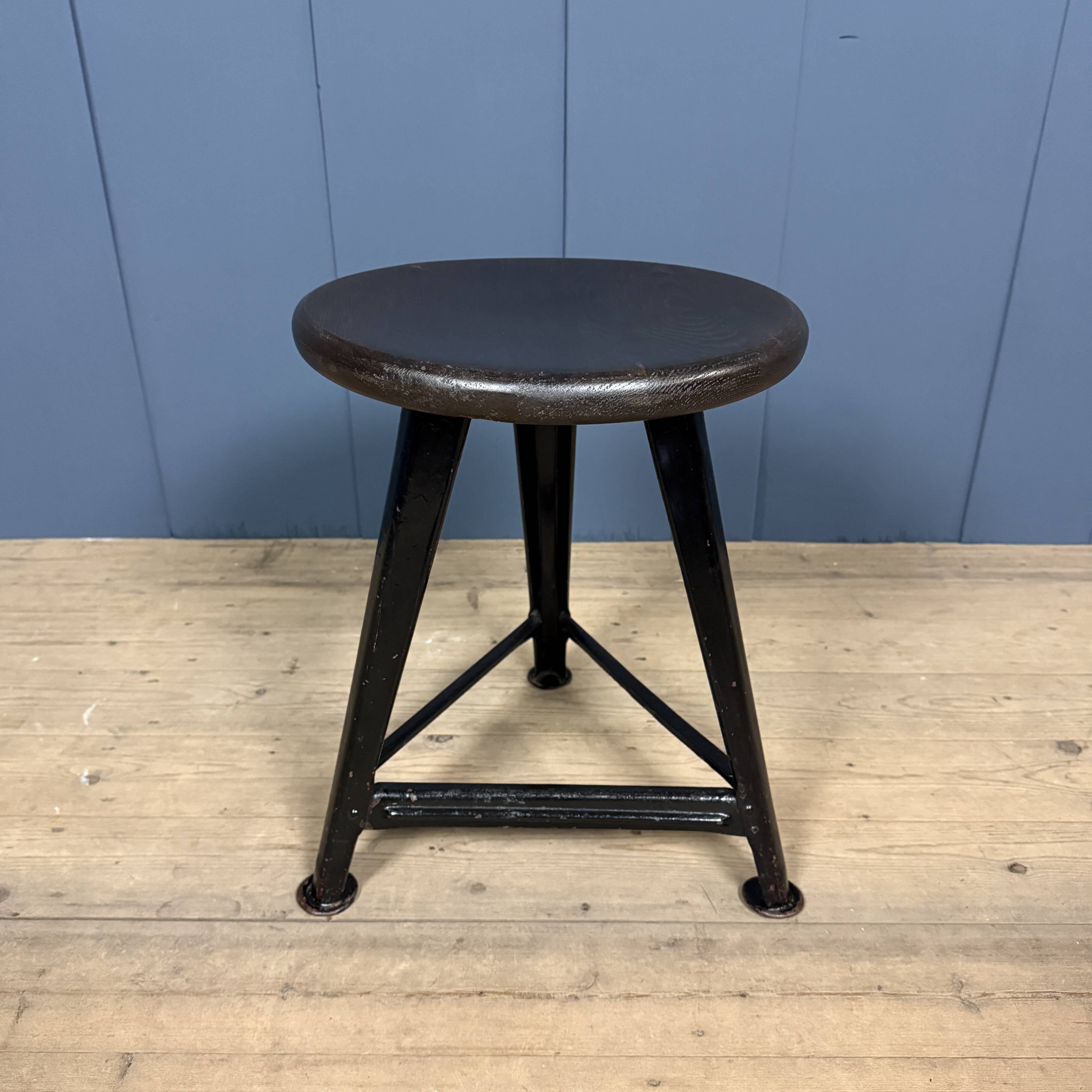 Unmarked black Rowac stool with a dark wood seat.