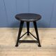 Unmarked black Rowac stool with a dark wood seat.