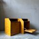 Pair of handcrafted solid wood bedside tables with drop-down doors.