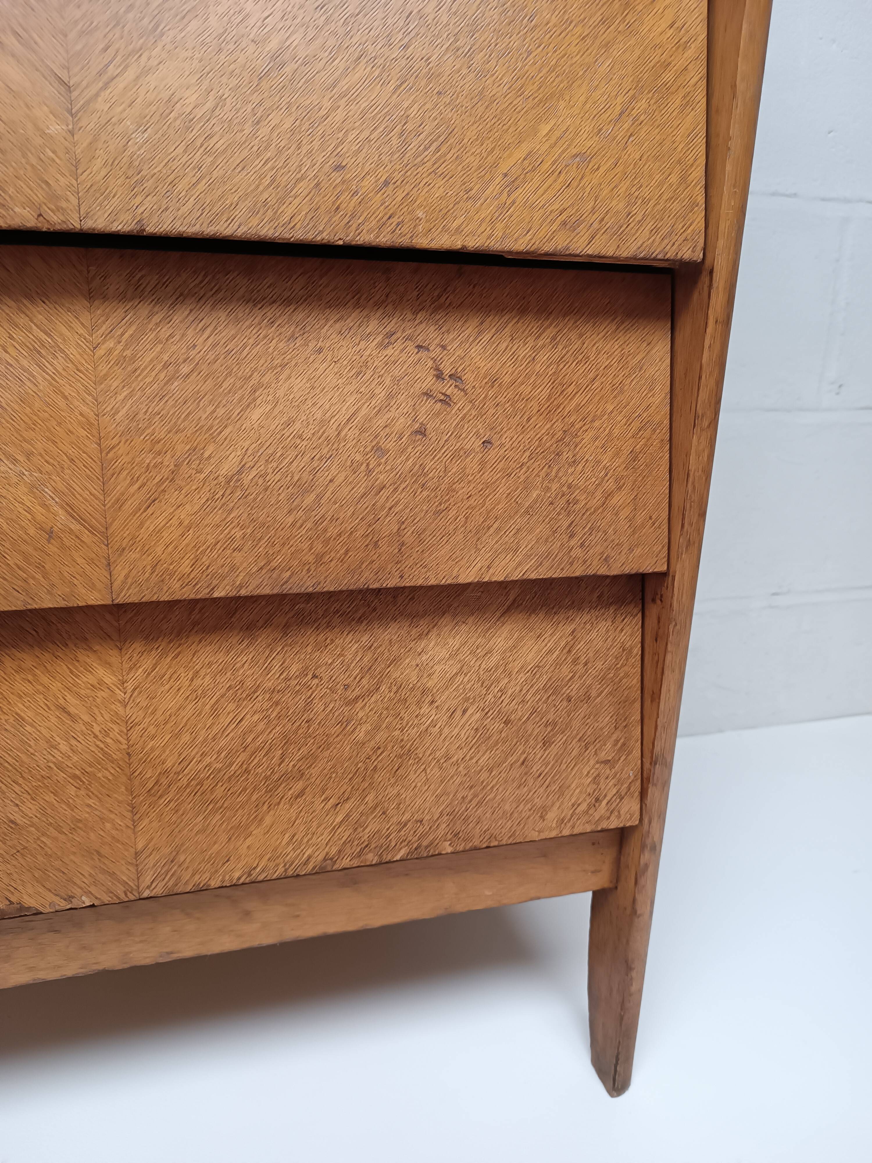 High wooden chest of drawers in the 50s