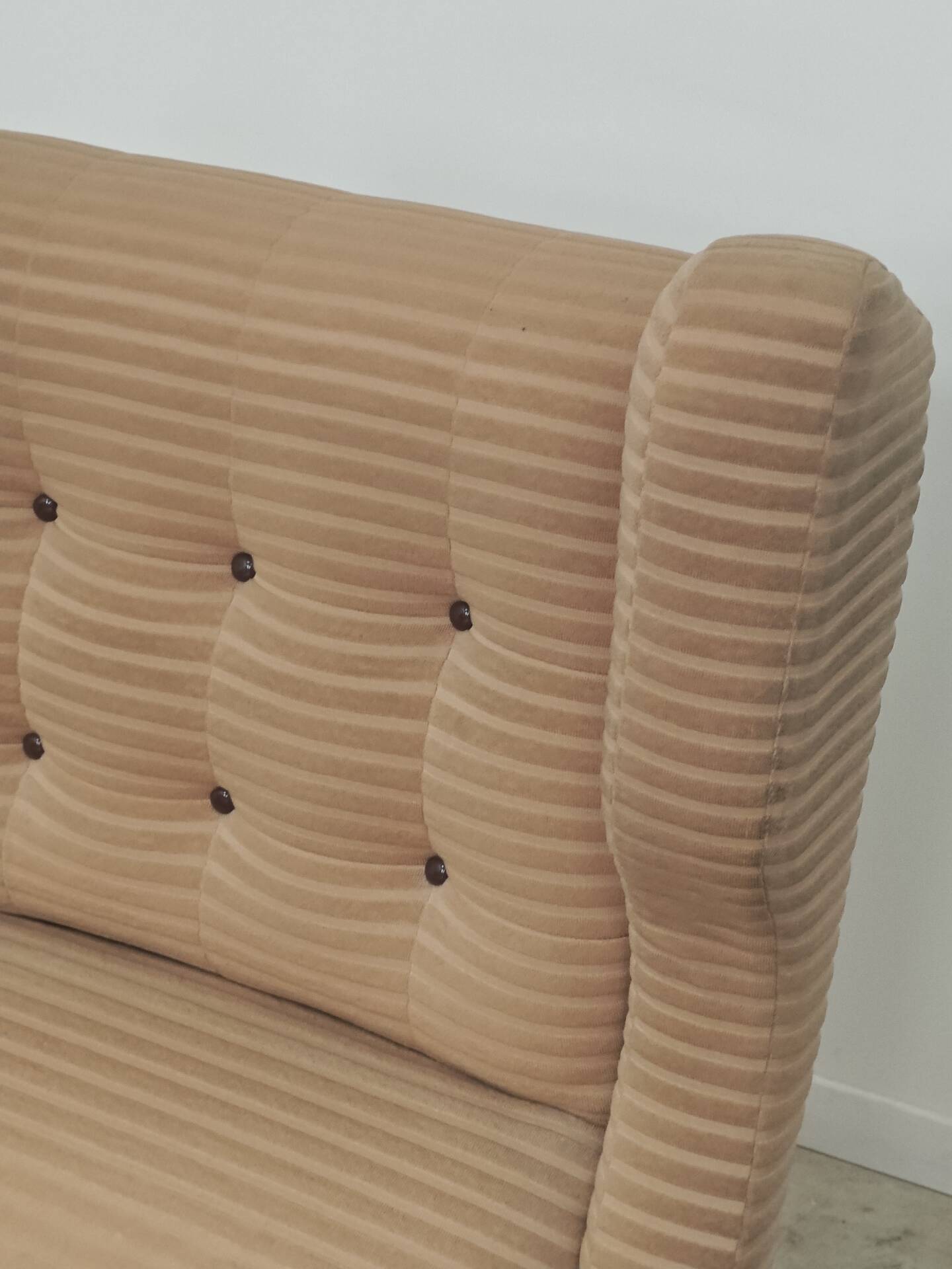 Beige wingback armchair and TVAR footrest, former Czechoslovakia.