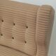 Beige wingback armchair and TVAR footrest, former Czechoslovakia.