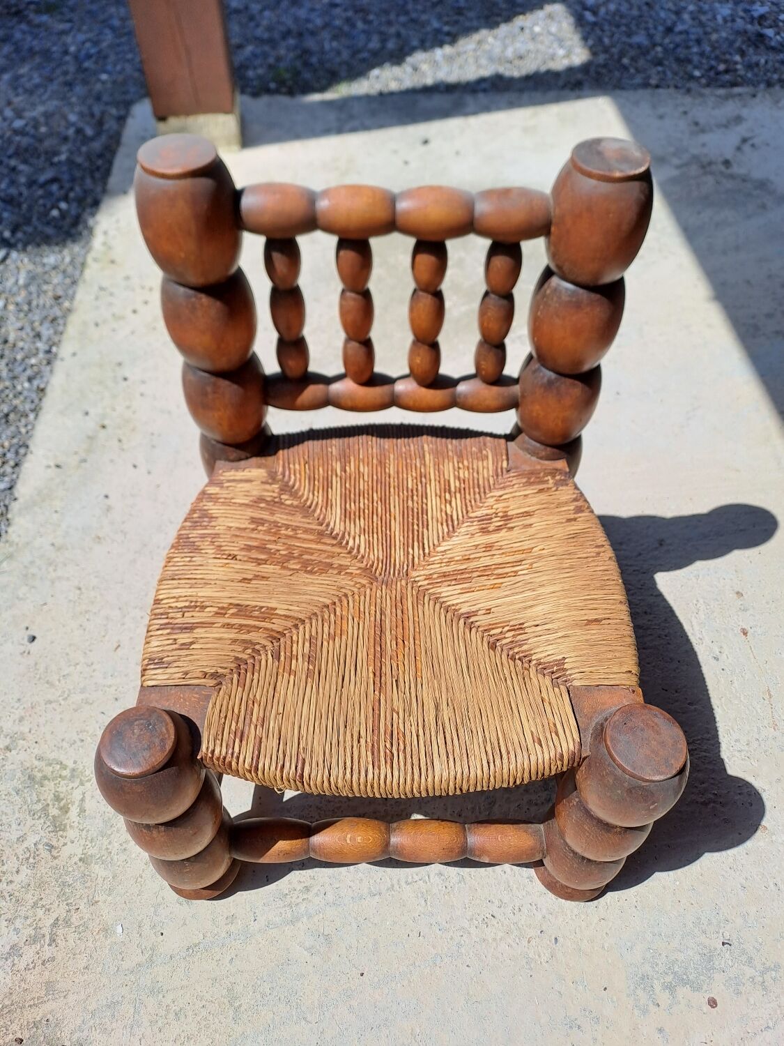 Low chair 50s oak and straw by the fire