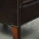 Dark cow leather club armchair with a stylish design in English style