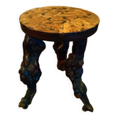 Brutalist tripod stool made from vine stumps.