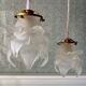 Deux suspensions vintage Globe fleur en verre dépoli