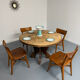 Round table in solid wood, thick top, vintage brutalist style from the 1960s.
