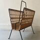 Black metal and rattan magazine rack by Raoul Guys, 1950.