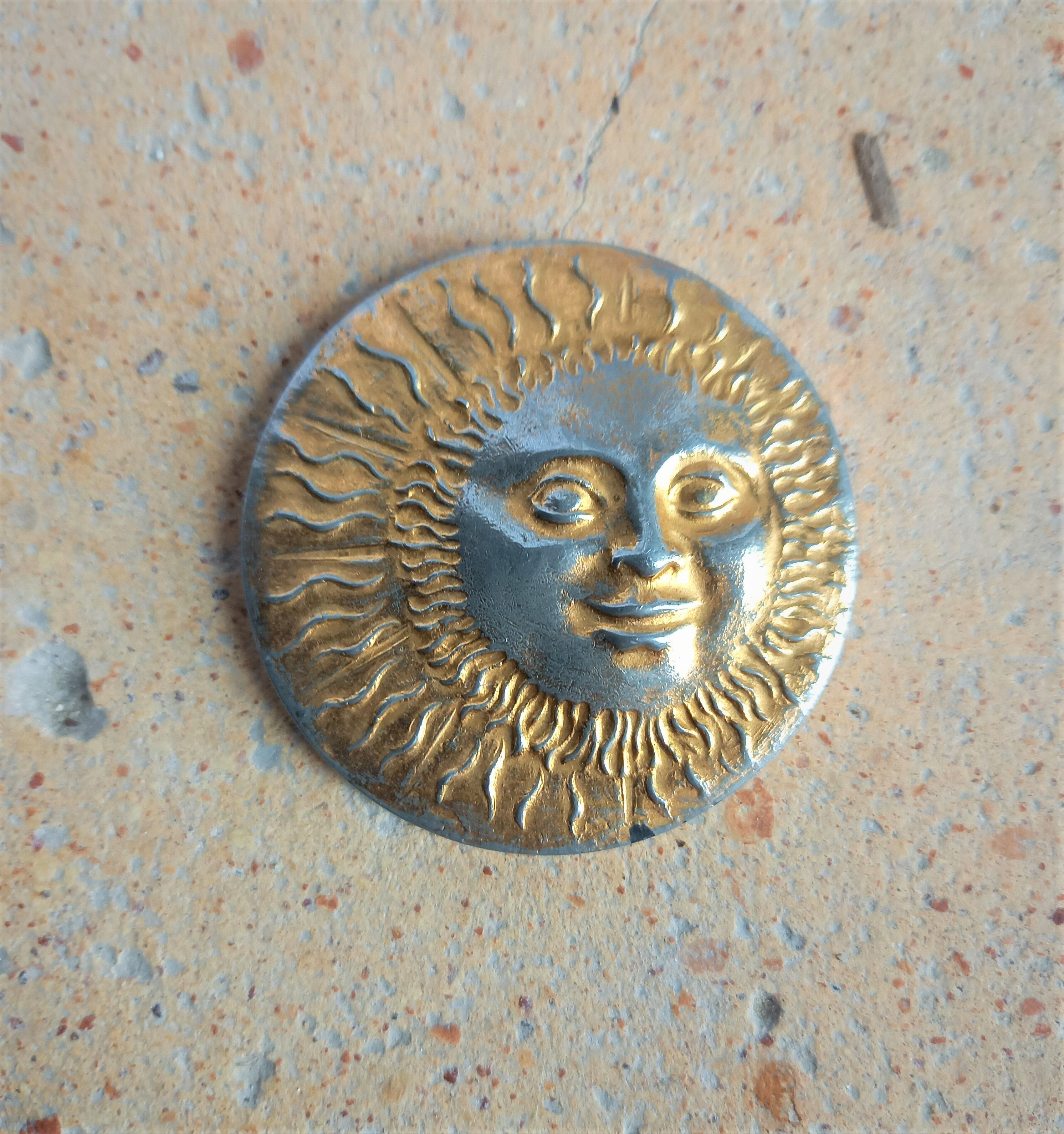 Brass sun paperweight