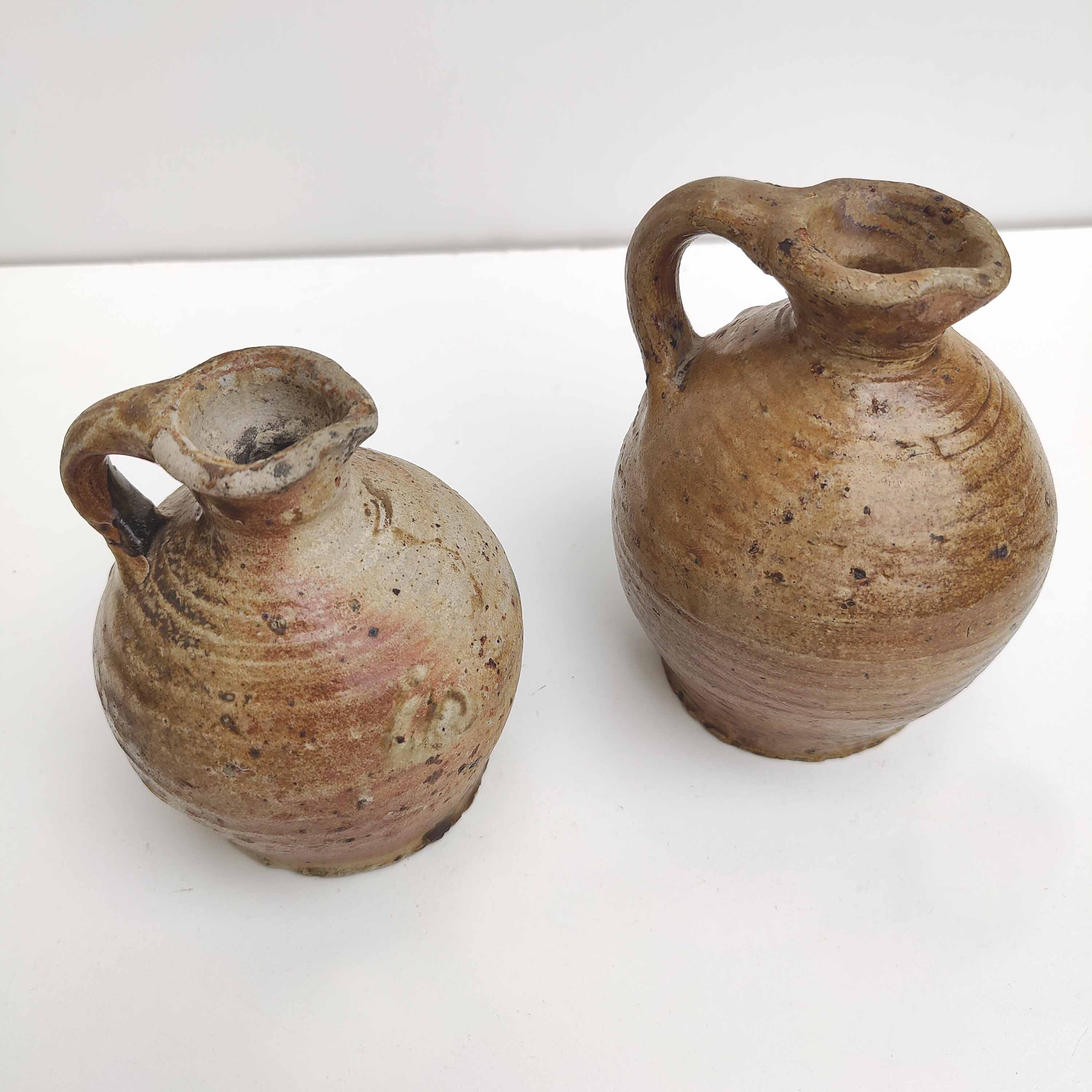 Set of two small sandstone pitchers