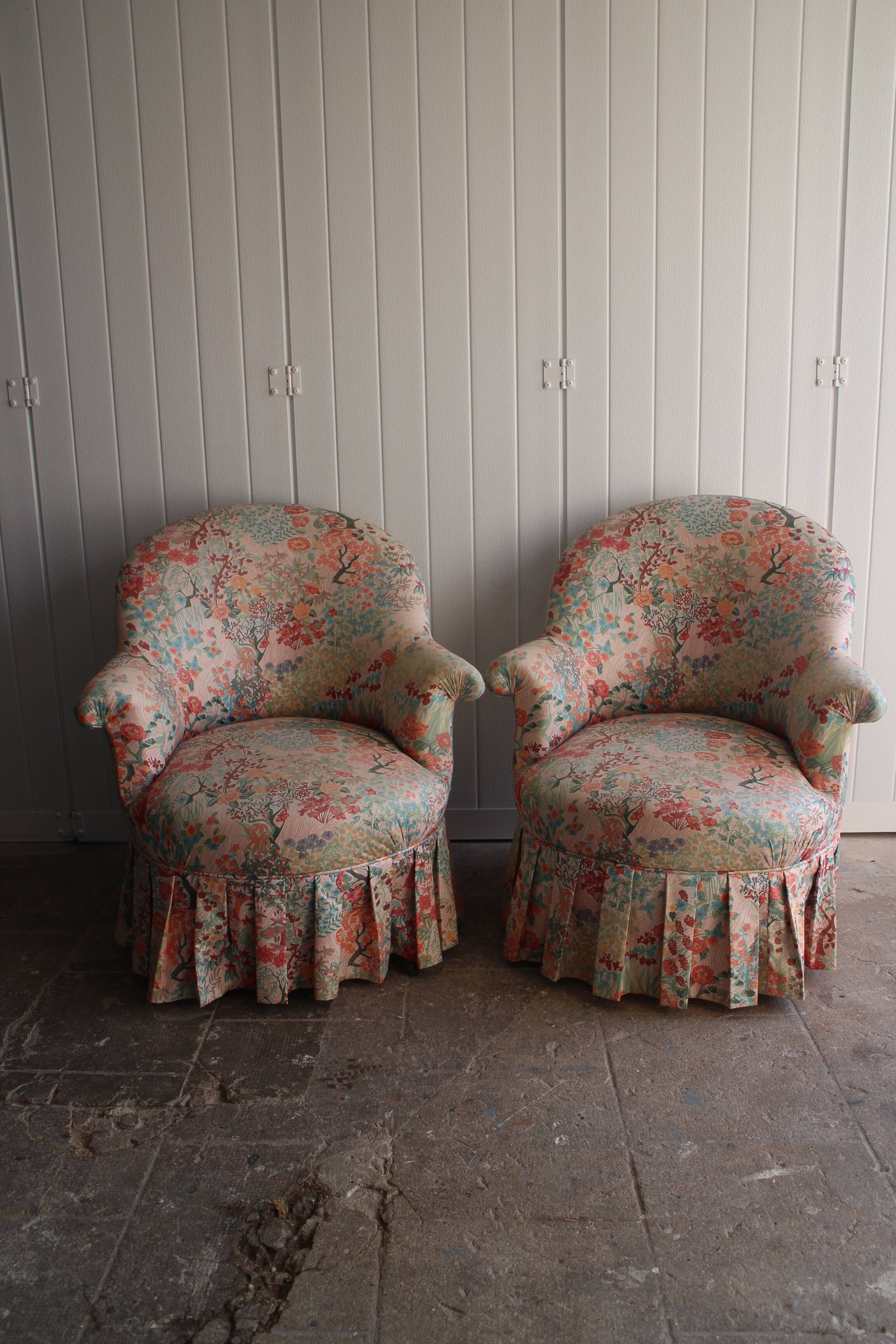 pair of toad armchairs in floral fabric.
