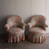 pair of toad armchairs in floral fabric.
