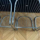 6 chrome metal chairs in the style of Gastonne Ronaldo.