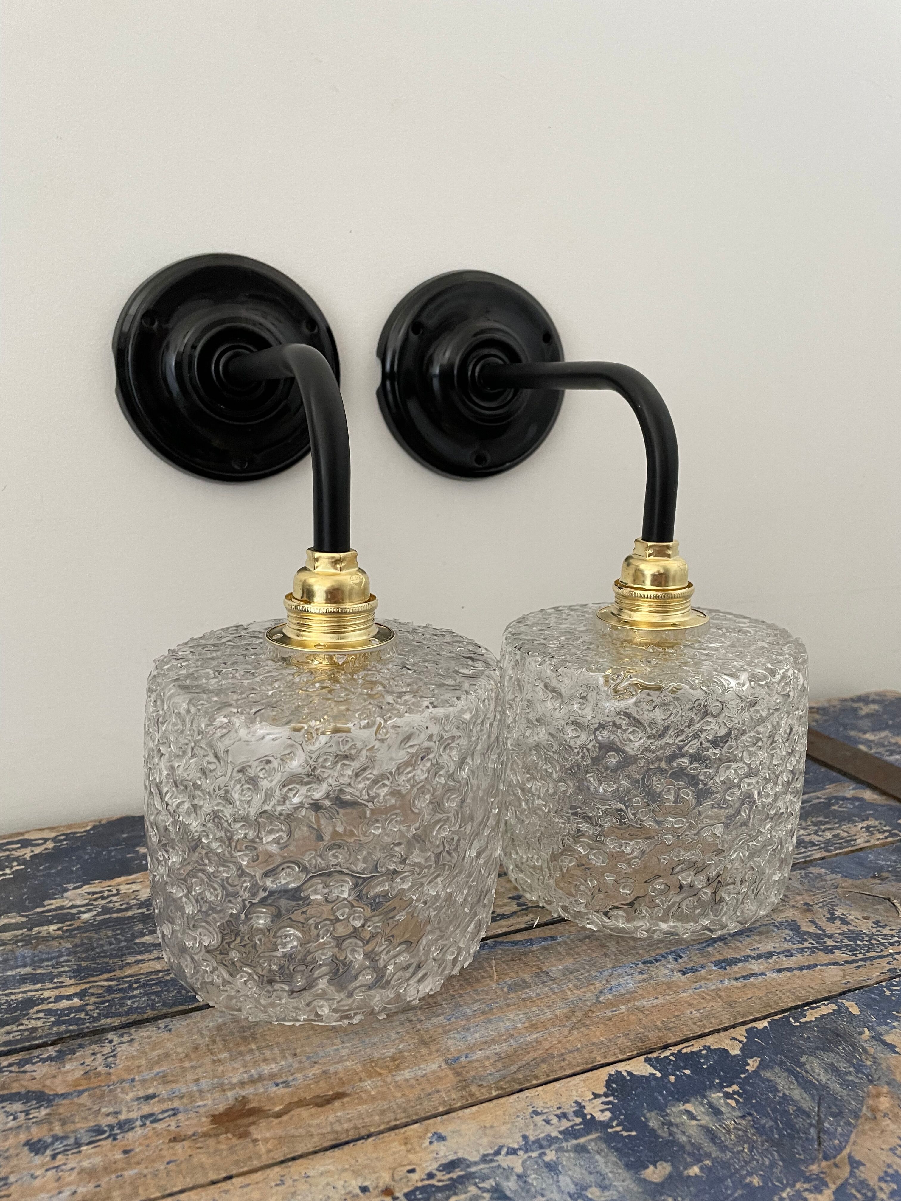 Set of two chiseled glass sconces