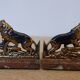 Small roaring lion bookends in patinated metal on a marble base.