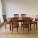 Oval dining table and 6 caned chairs in Louis XVI style made of wood.