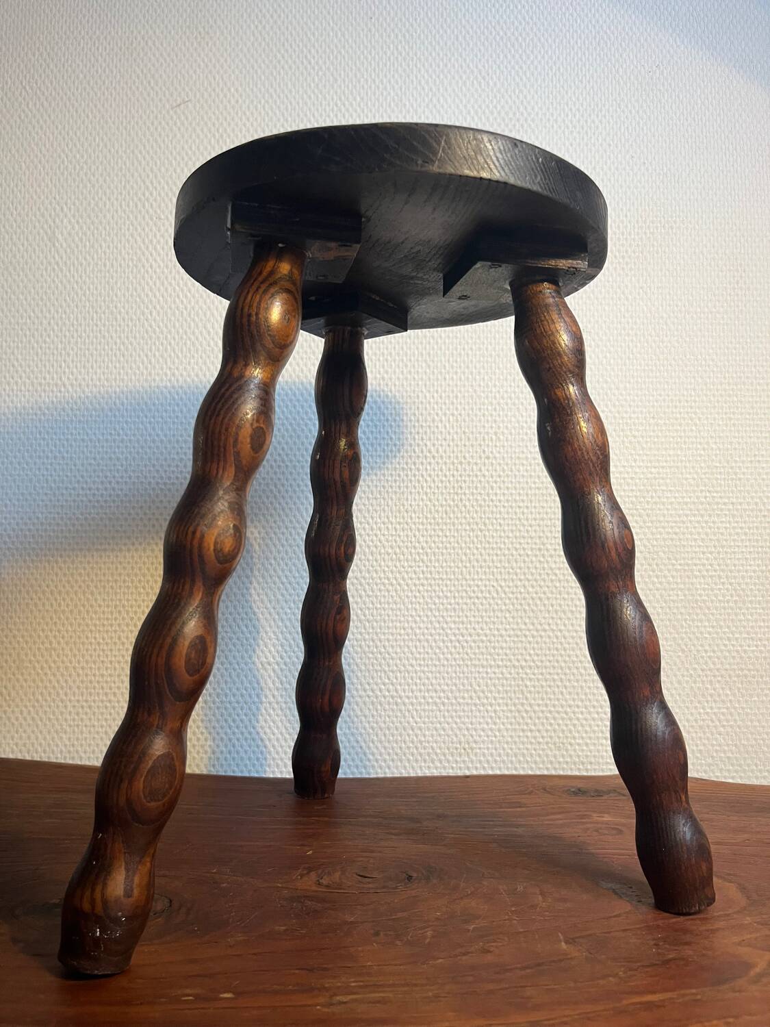 Round wooden tripod stool
