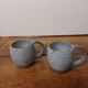 Two glazed stoneware mugs