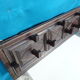 Wall-mounted coat rack in solid oak with 9 hooks.