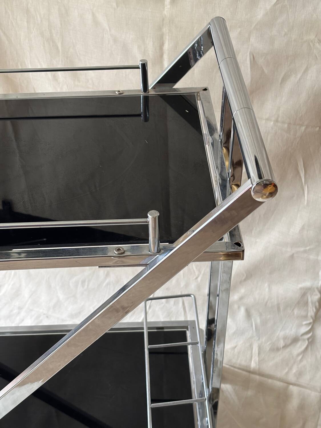 Modernist serving trolley in chromed metal and black smoked glass