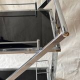Modernist serving trolley in chromed metal and black smoked glass