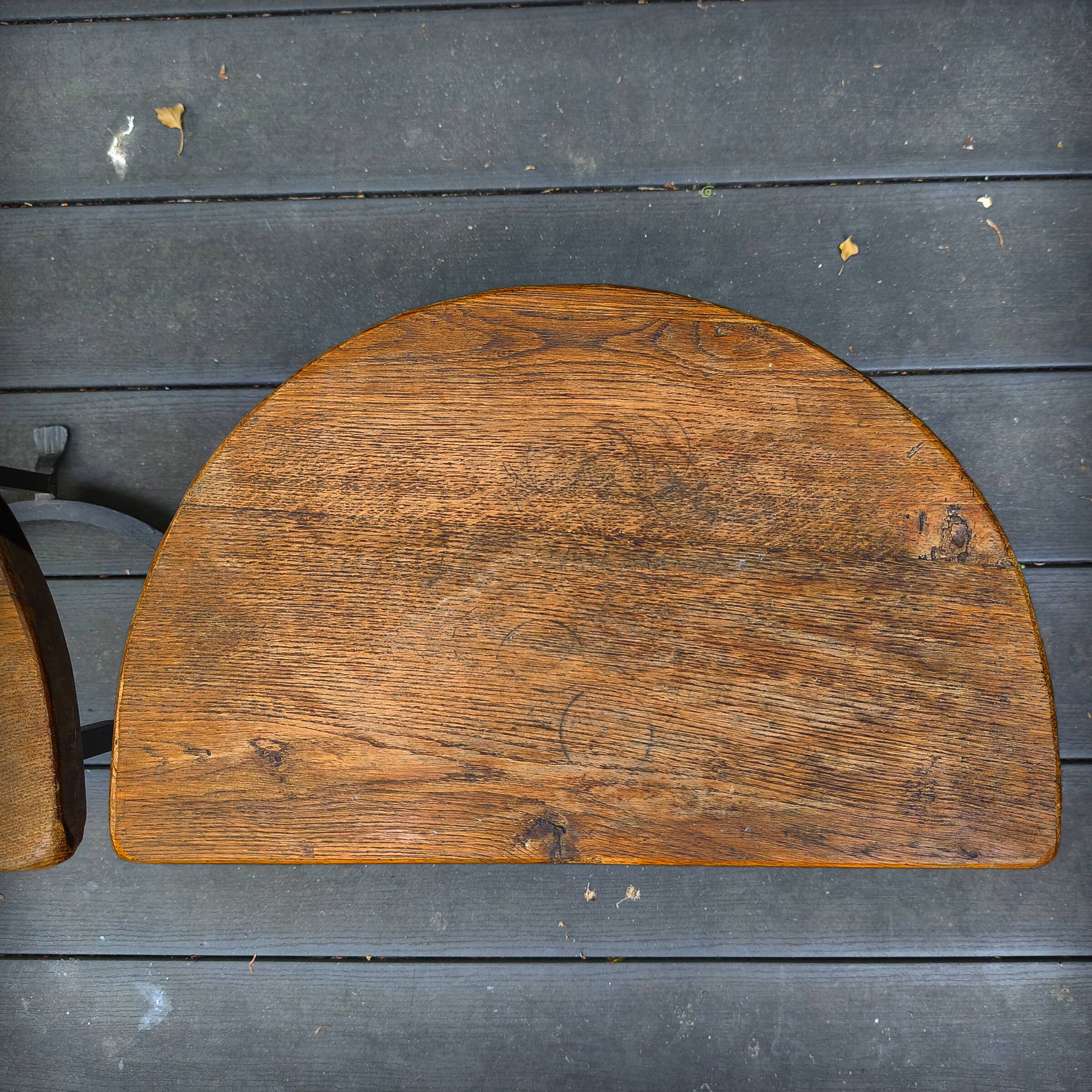 Pair of wrought iron and oak side tables, France, 1930.