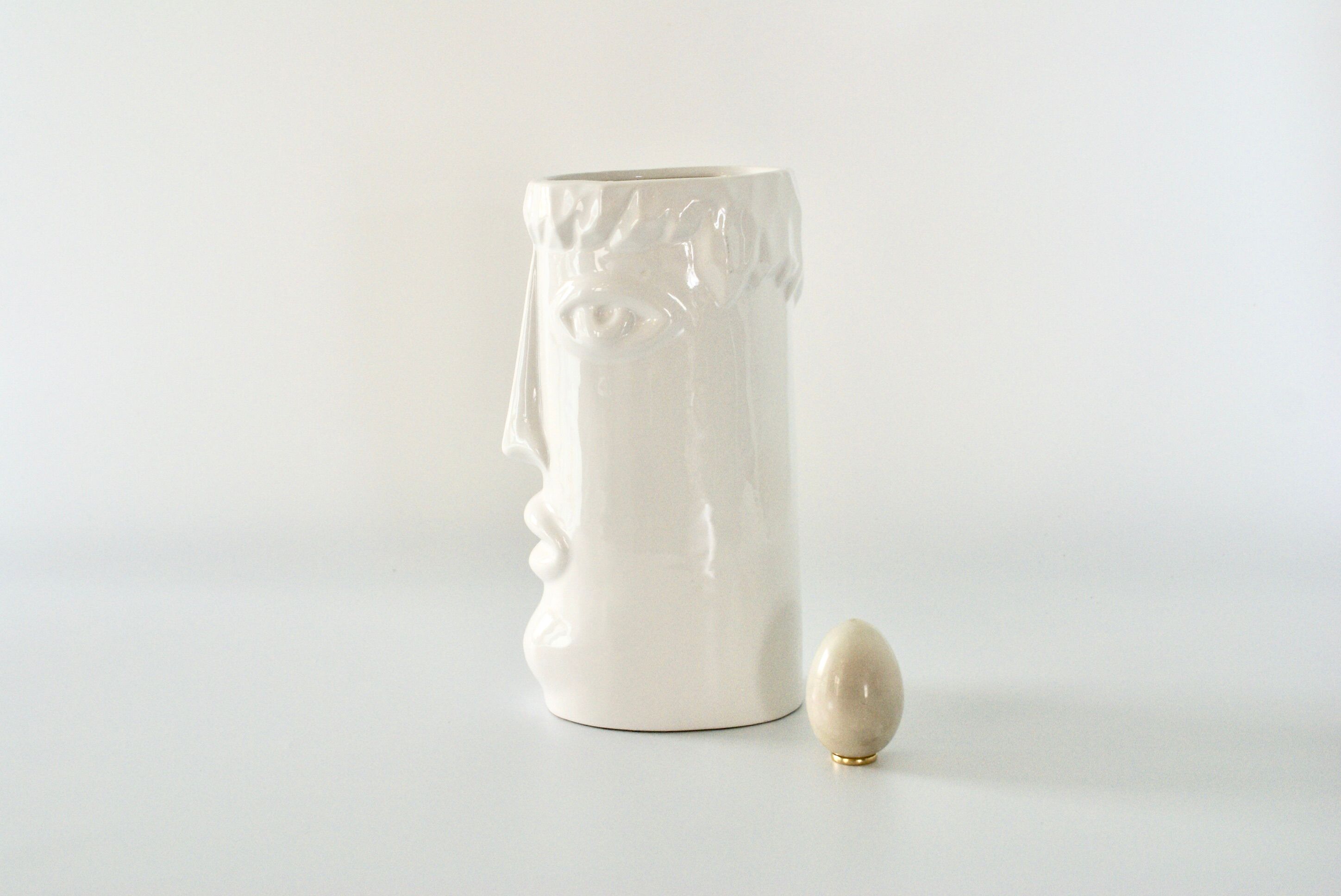 White glazed ceramic vase with face
