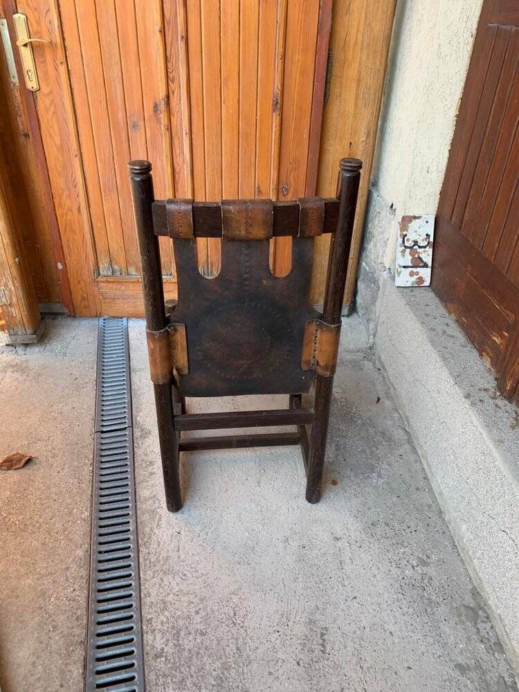 Handcrafted brown leather armchair, dark wood frame, circular pattern - 1970s.