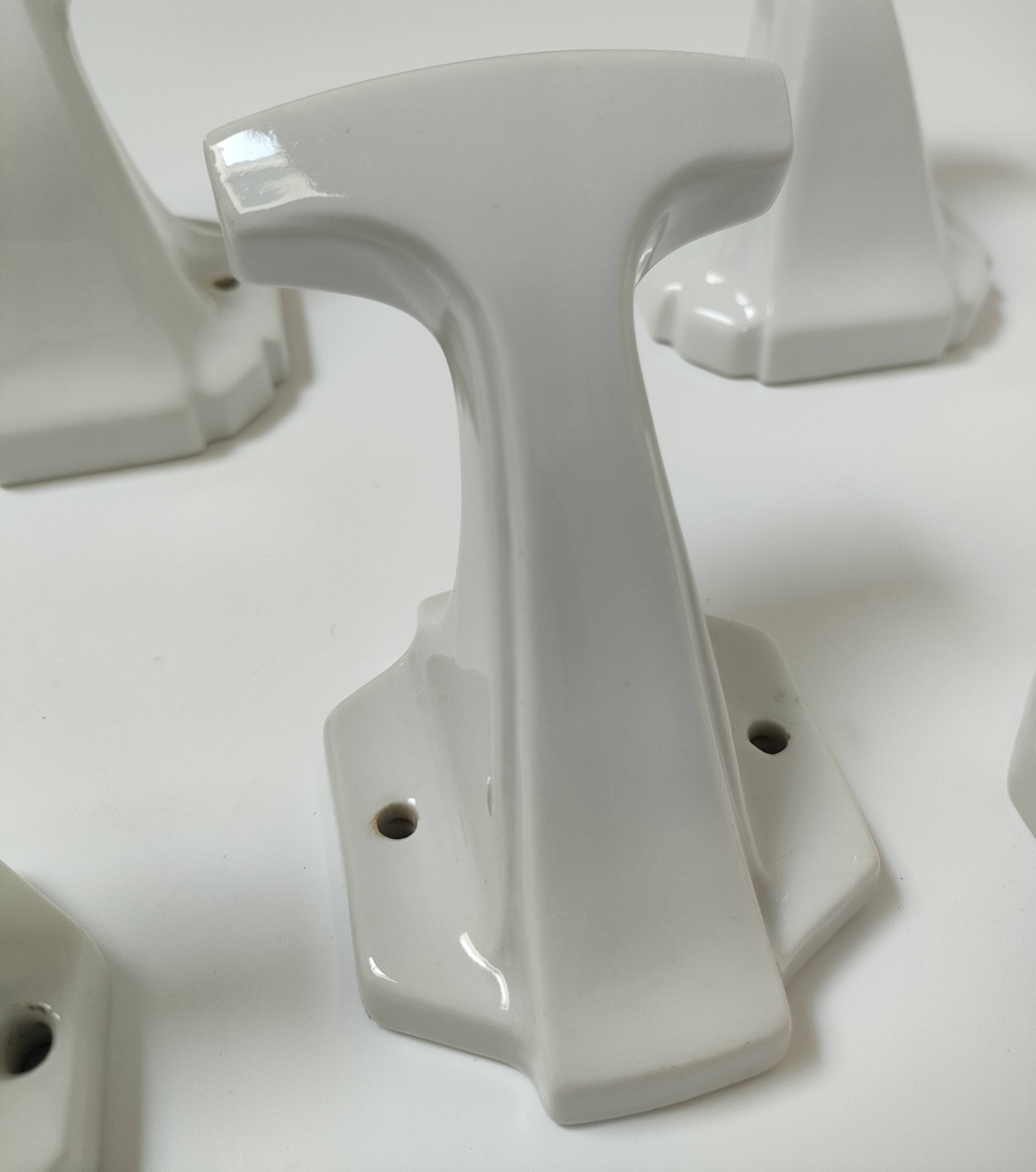 Five art deco white porcelain hooks