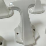 Five art deco white porcelain hooks