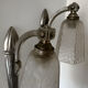 Silver Art Deco wall lights with frosted glass.
