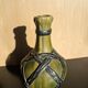 Miniature vase encircled with woven black brass.