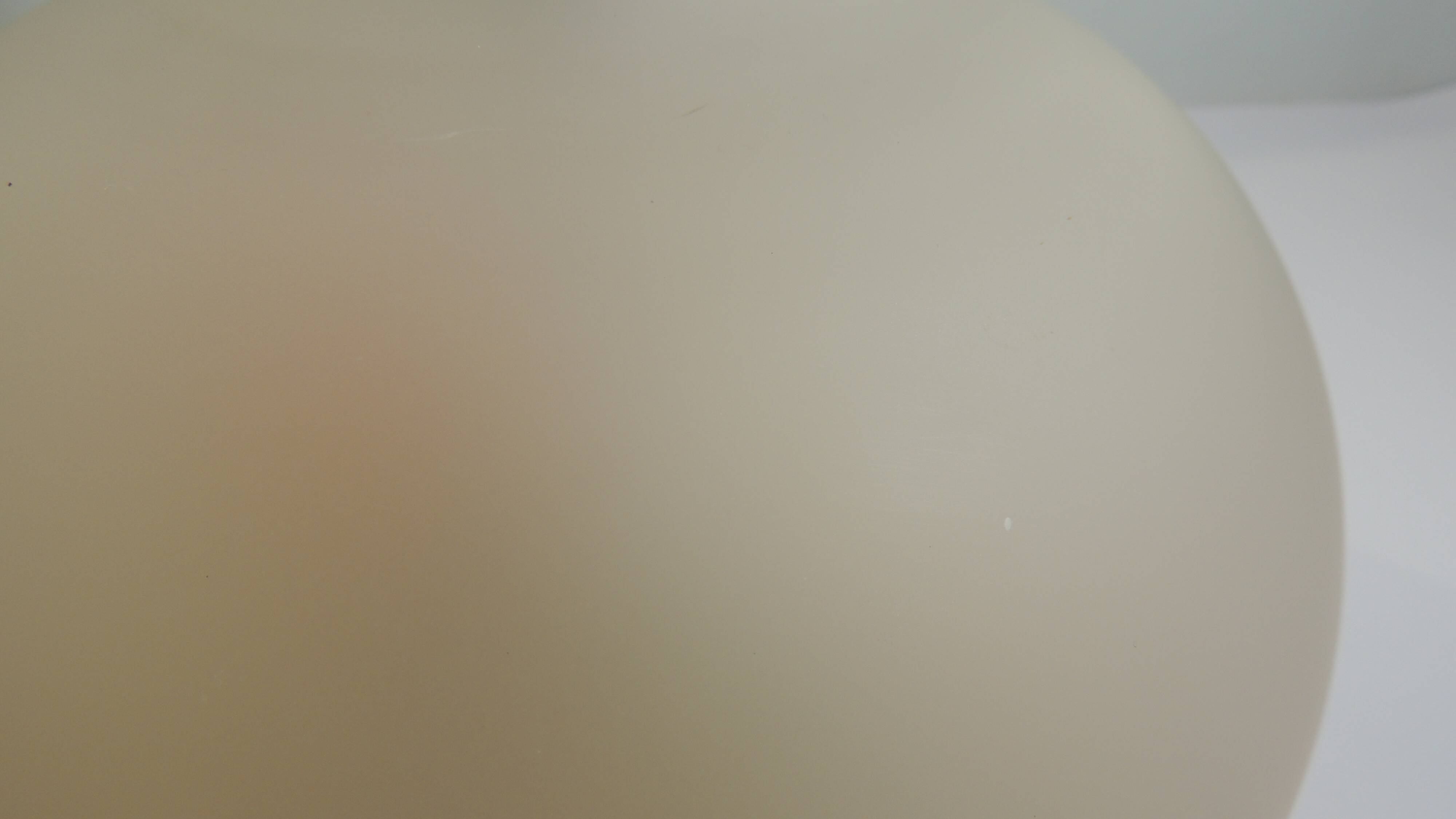 Vintage frosted glass lamp, round globe, elegant design, soft light.