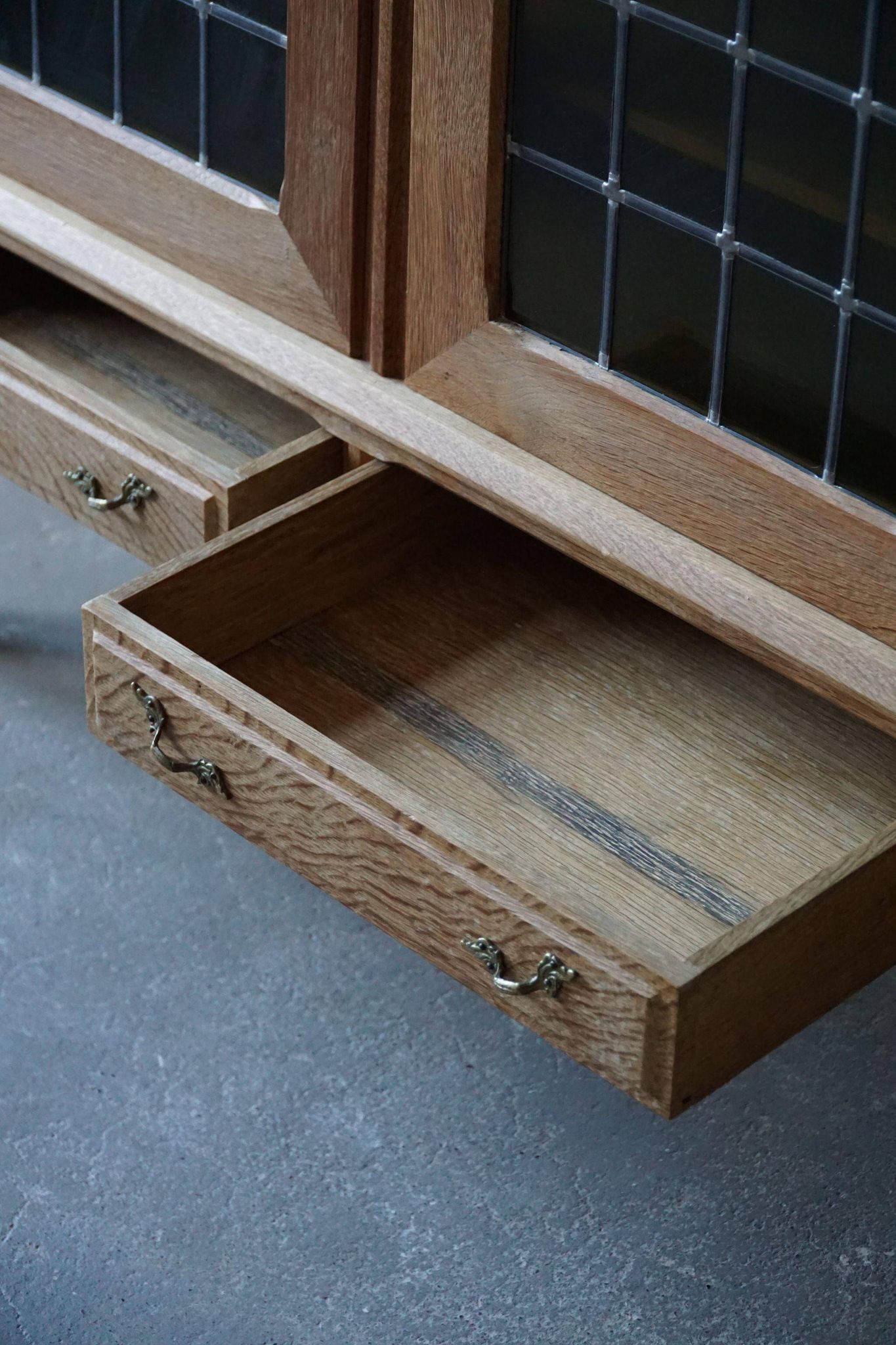 20th-century mid-century solid oak sideboard with glass front, by a Danish cabinetmaker.
