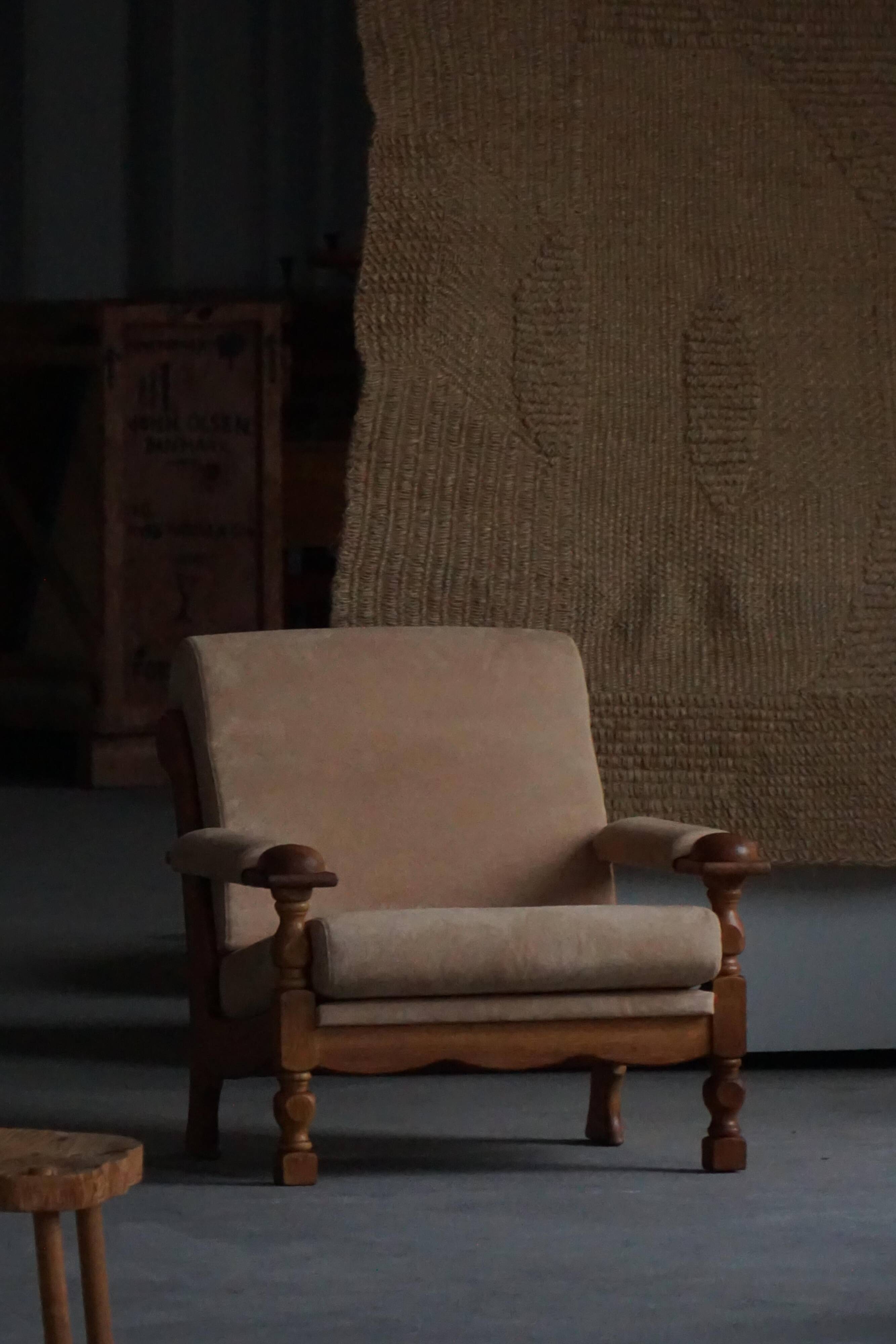 Pair of armchairs by Henning Kjærnulf, Oak Oak and Alcantara, mid-20th century, 1960s.