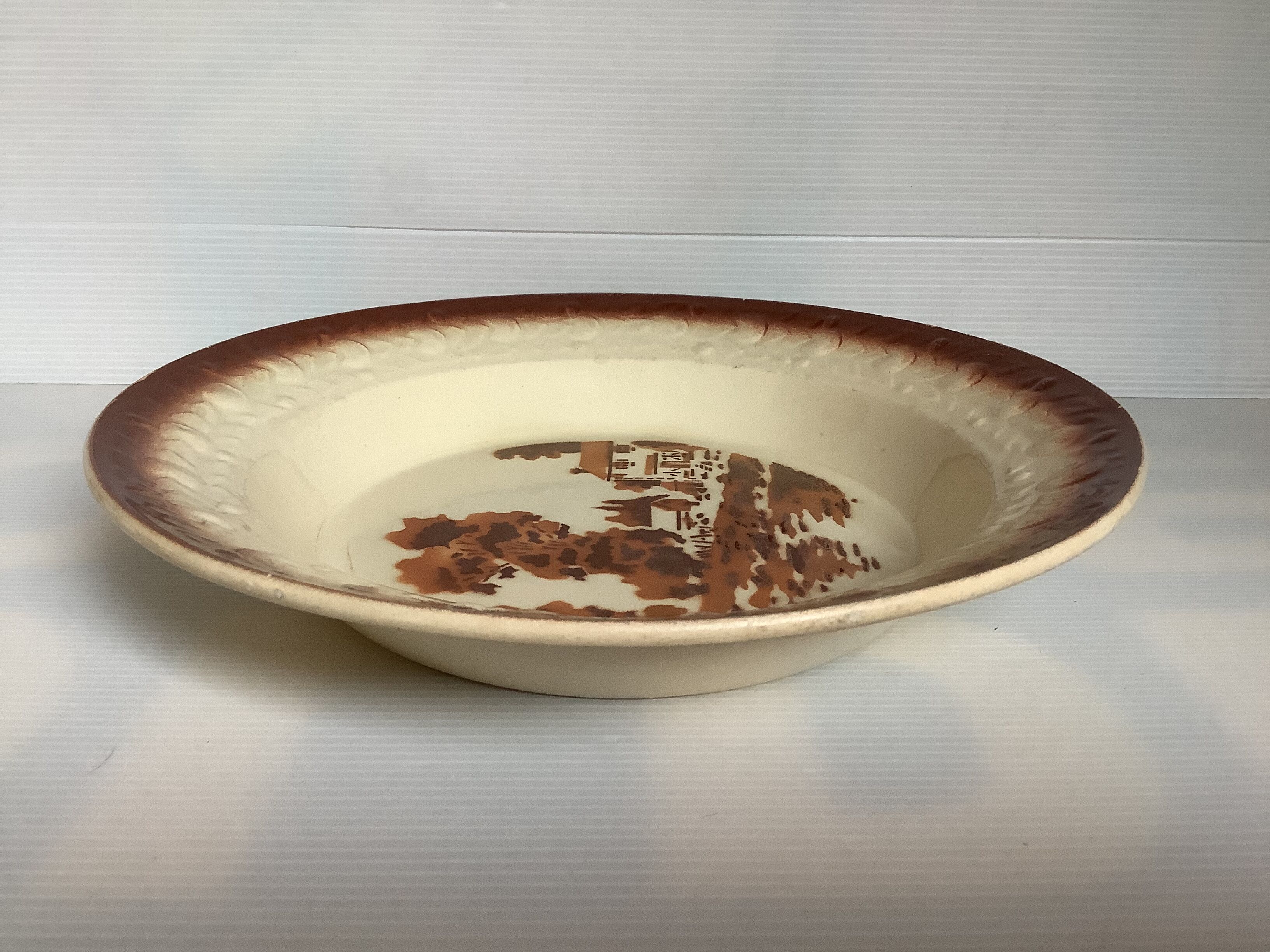 Earthenware plate from Moulin des Loups with stencil pattern.