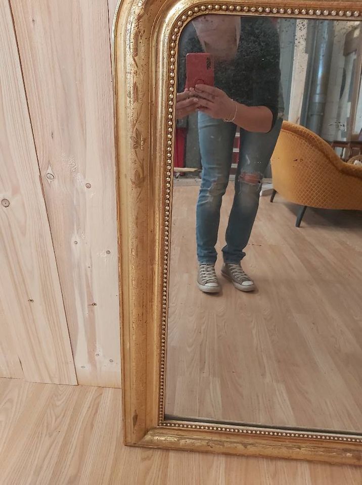 Golden Louis Philippe mirror with golden leafy