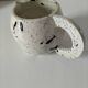 Small speckled ceramic jug in a vintage workshop style.