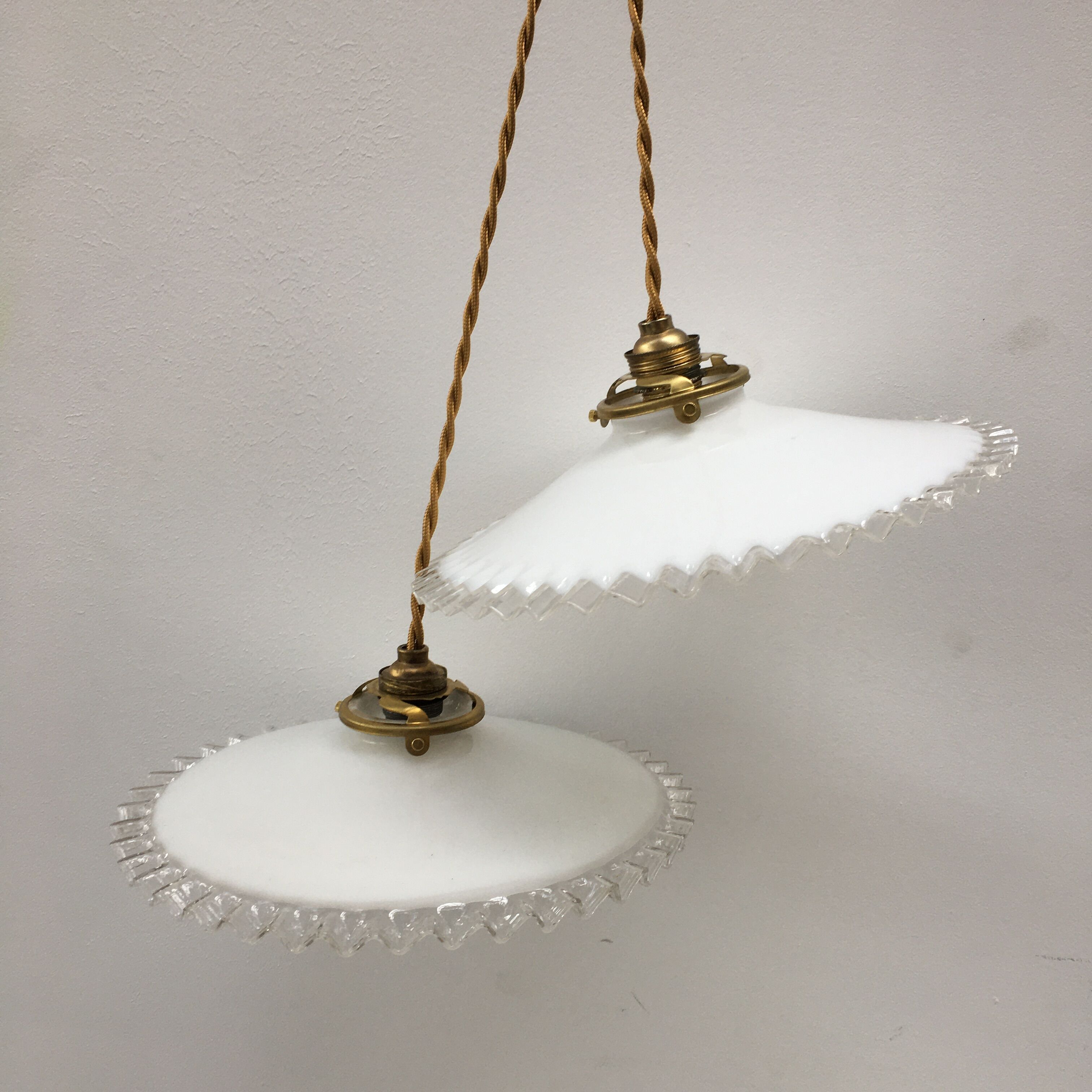 Pair of white opaline suspensions with serrated edges