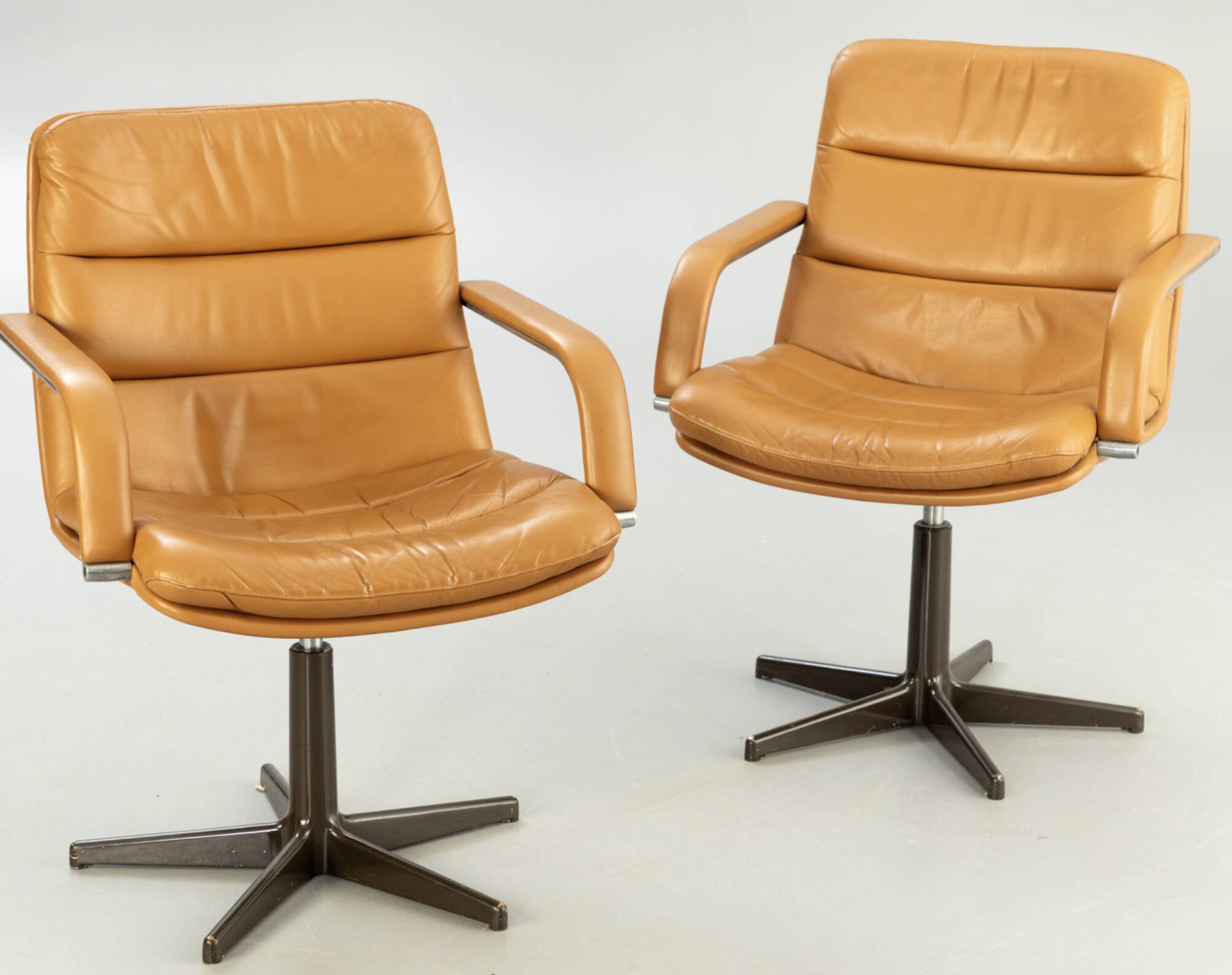 Pair of swivel armchairs by Geoffrey Harcourt.