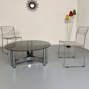 Round coffee table in smoked glass and chrome steel, 1970s design.