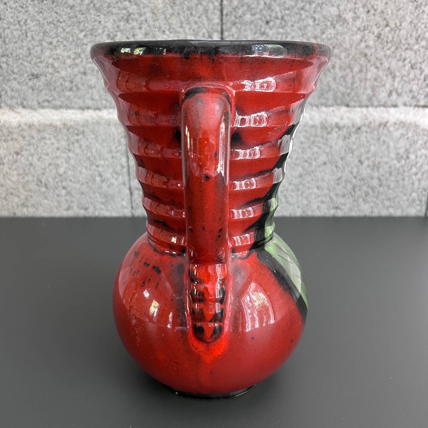 Red vase with floral decoration
