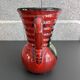 Red vase with floral decoration