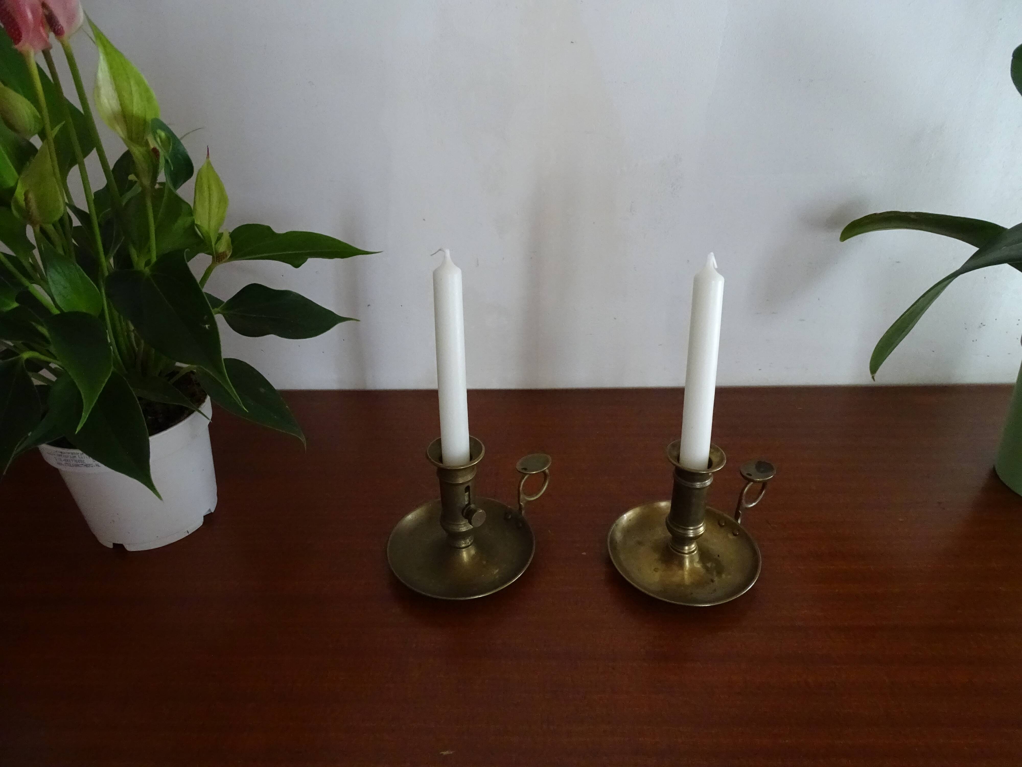 Pair of vintage brass pusher candle holders