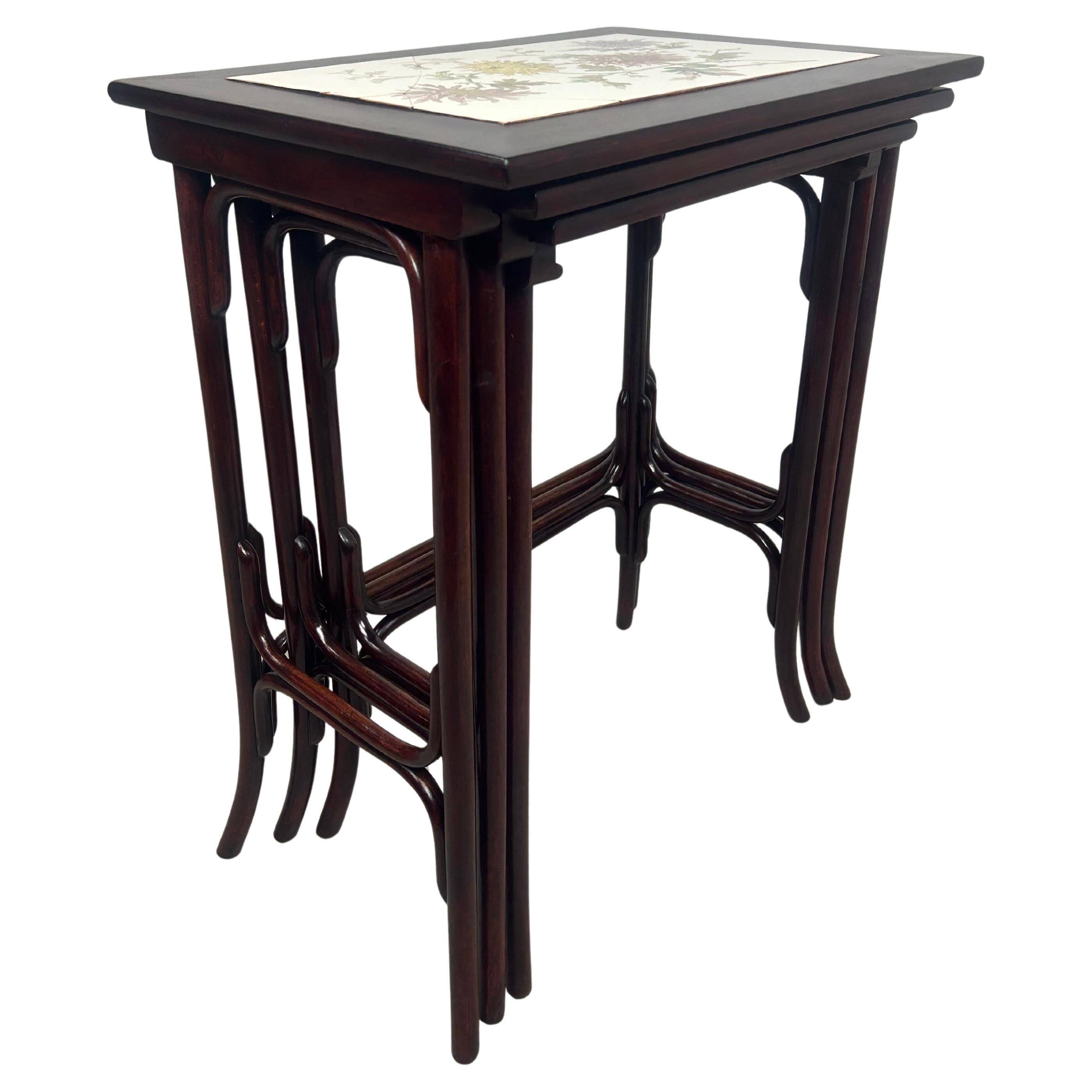 Nested tables in curved wood with ceramic top by Thonet.