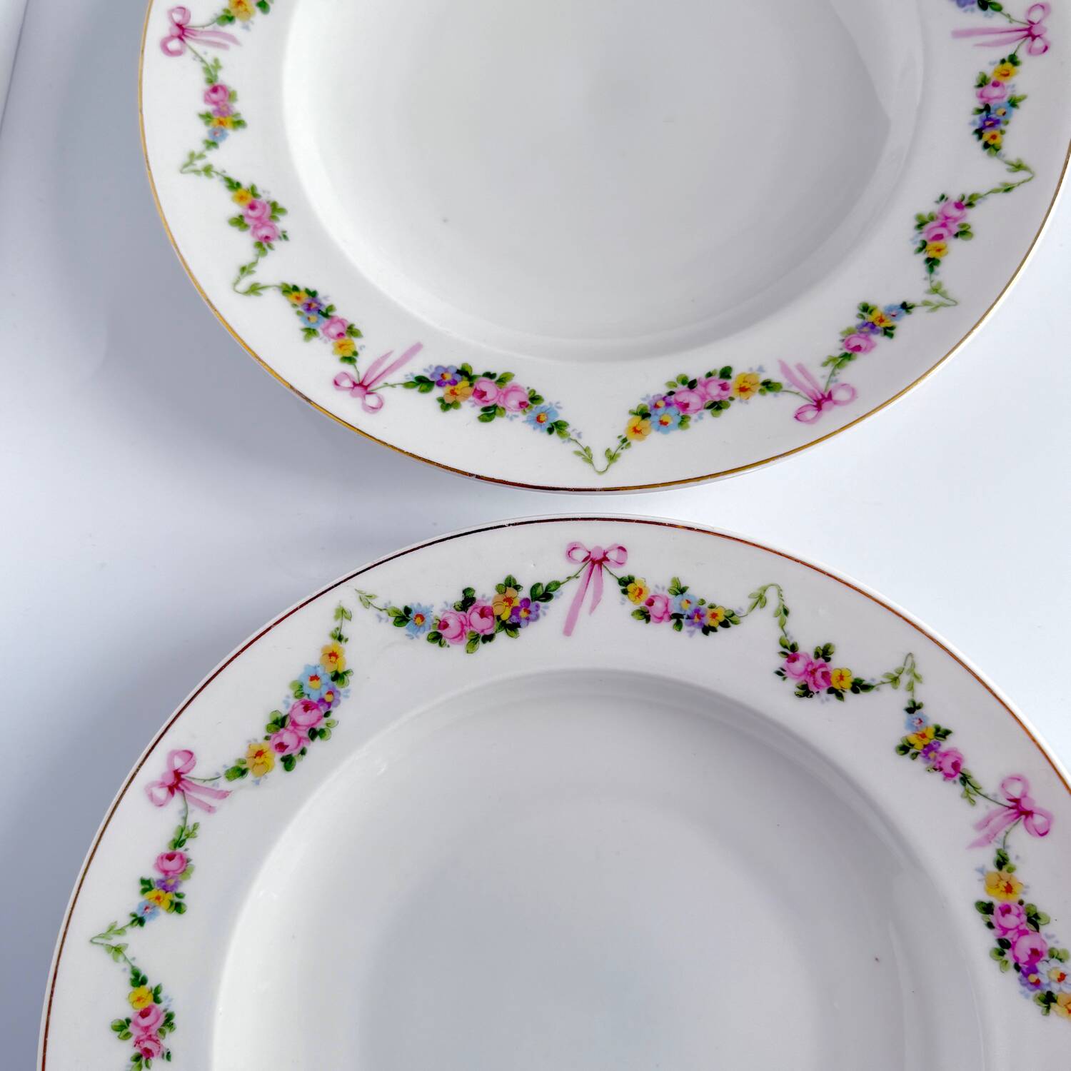 Pair of soup plates by EPIAG | ribbons/bows and garlands