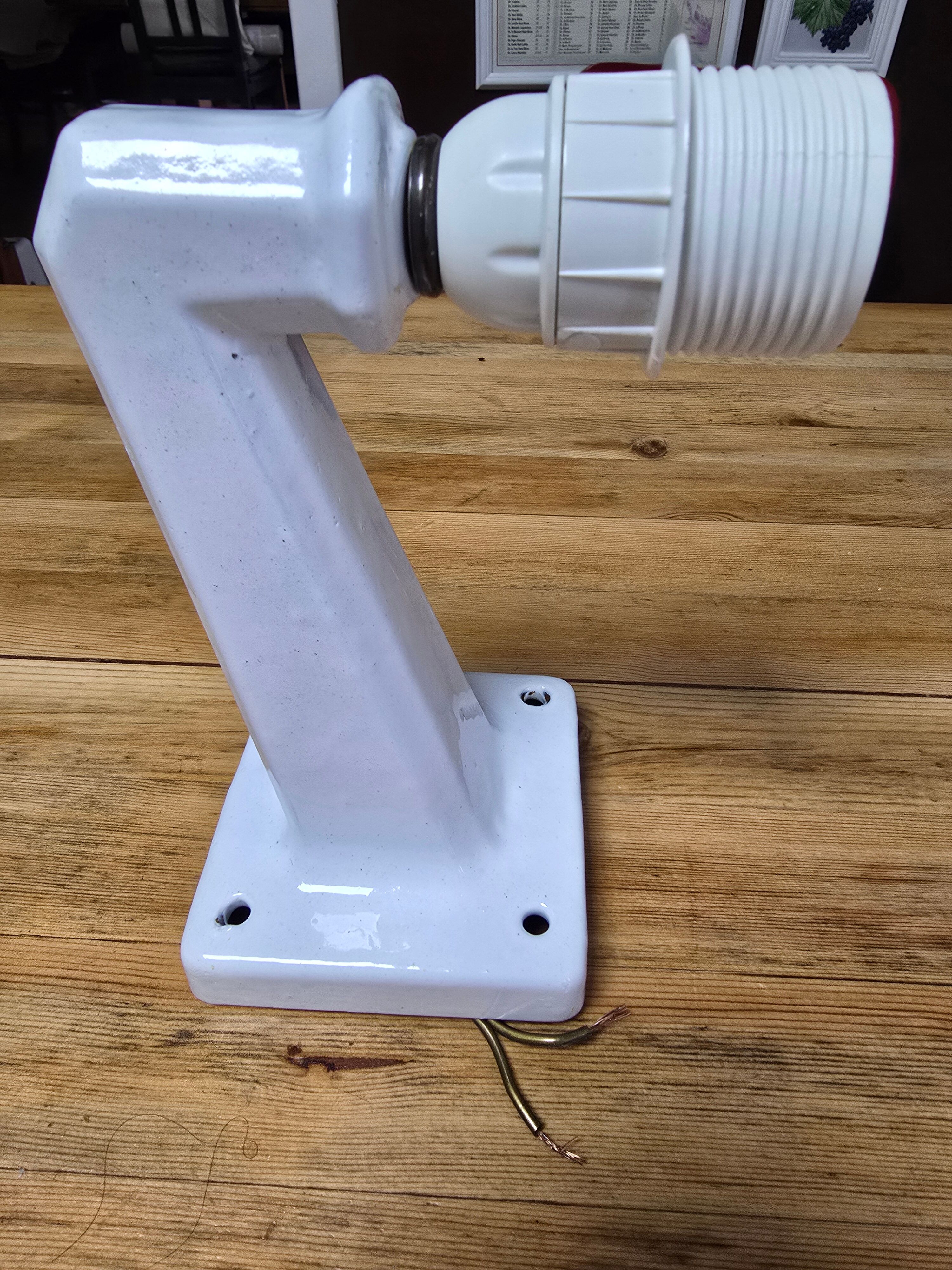 Antique wall light in porcelain with a new socket.