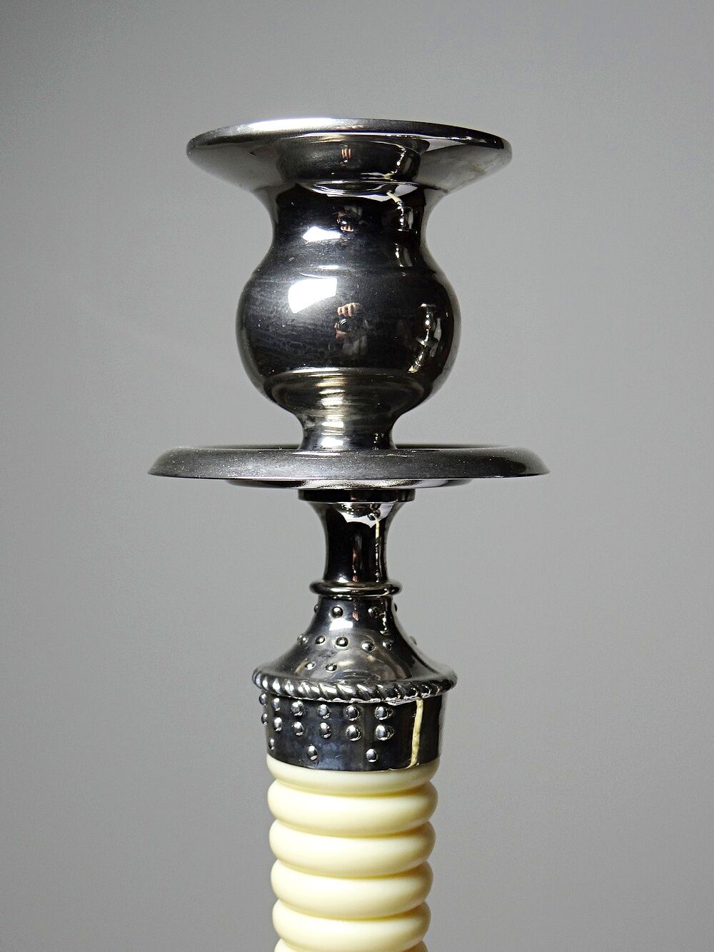 Pair of vintage candlestick holders in silver-plated metal with ivory-style plastic.