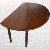 Oval walnut table with flaps